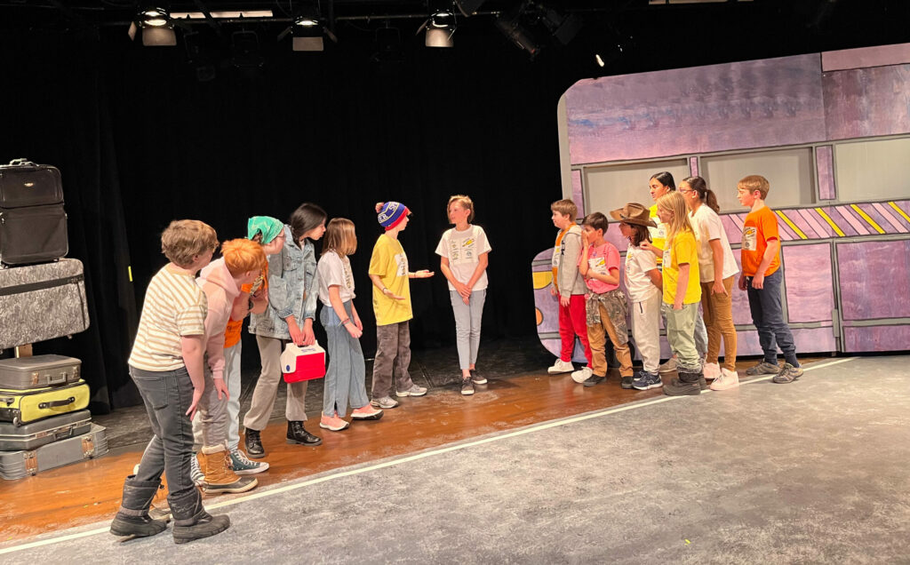 A group of 10 to 12 year old kids performing a play