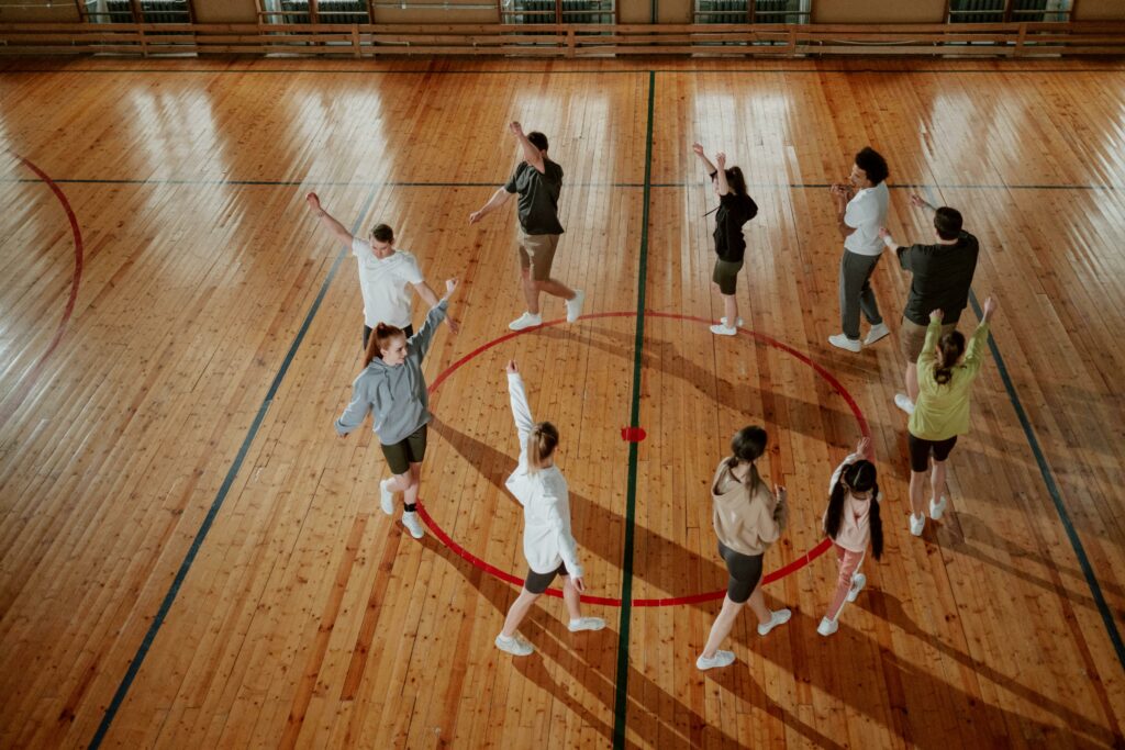 kids walking around in a circle with arms stretched out to the sides